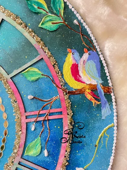 A close-up of the charming, colorful birds painted on the galaxy clock, adding a narrative element to the piece.