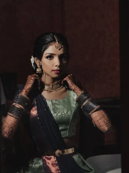 An artistic, low-light shot. The makeup is still defined and beautiful, showcasing its versatility.