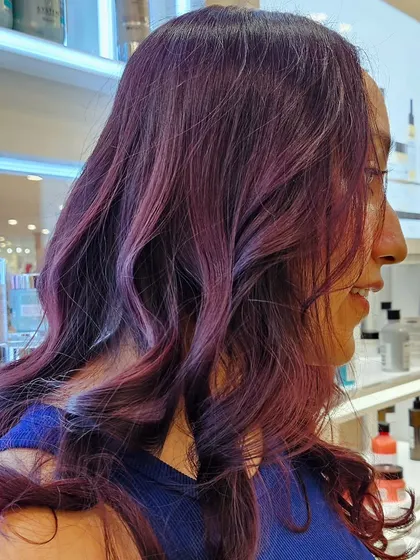 Set the world on fire with bold hair. This vibrant magenta color is a true statement, showing off her personality and confidence.