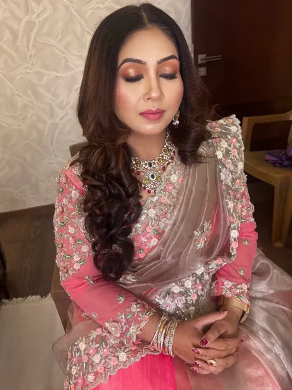 A gorgeous reception look featuring soft curls and a copper-toned smokey eye. This style is perfect for an elegant evening affair.