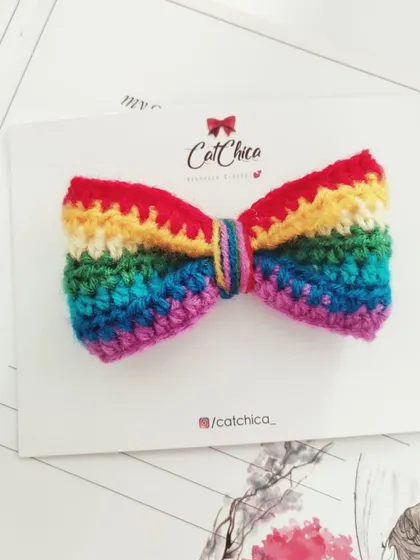 A classic rainbow hair bow, perfect for adding a cheerful touch to any day.