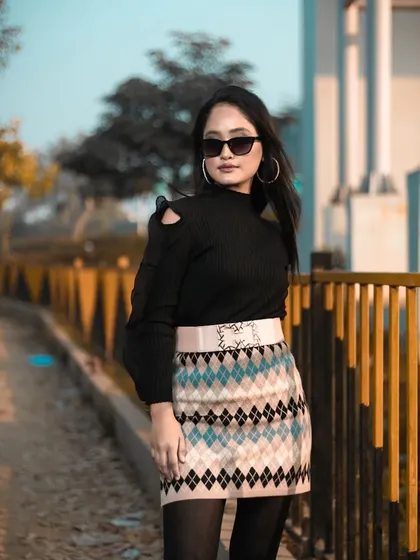 A full-body shot showing the complete winter outfit, from the sunglasses to the platform boots, with makeup to match.