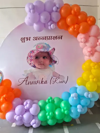 A clear photo of the Annaprashan ceremony backdrop and balloon decor.