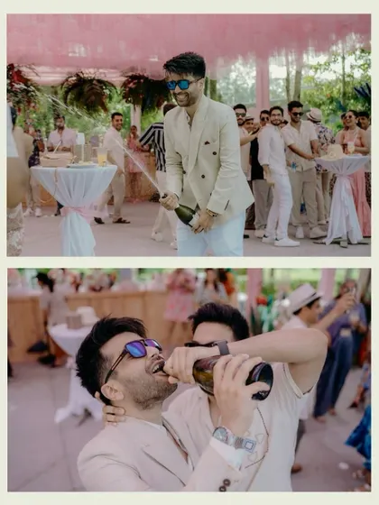 Capturing the fun and celebratory mood of the pool party. The groom pops a bottle of champagne and shares a laugh with his friends, showing the high-energy, candid side of the wedding events.