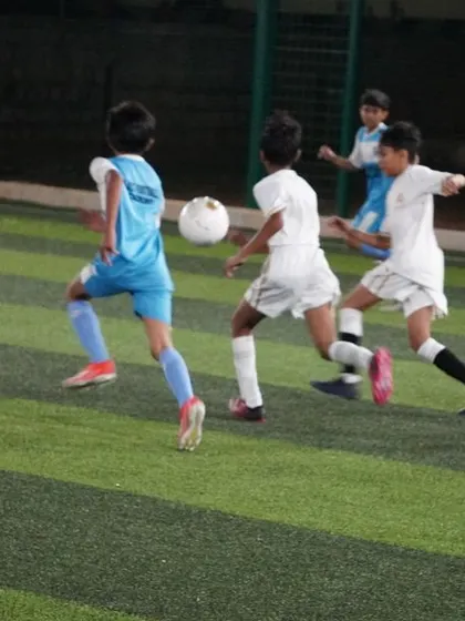 A group of players chase the ball, showing the high energy and competitive nature of our training games.