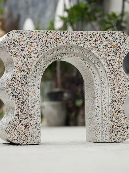 This sculptural terrazzo art piece was exclusively made to be used as a bookshelf. We love its playful curves and arches, which turn a functional item into a piece of decorative art.