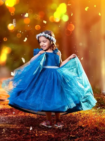 A princess twirling in an enchanted forest. The beautiful blue dress and the magical lighting effects come together to create a truly dreamy and captivating outdoor photo.