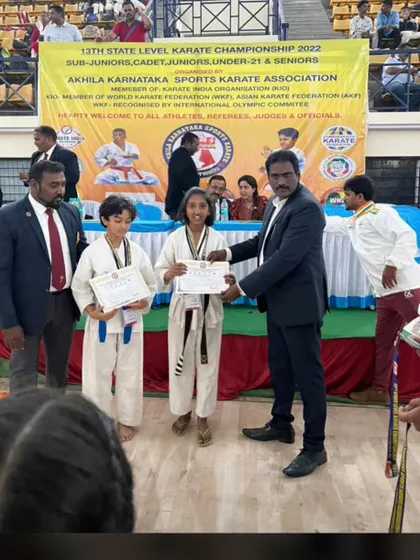 Two of our students being awarded their certificates and medals for their performance at the state level championship.