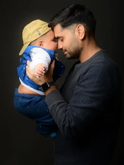 The color version of the tender moment between a father and his baby, highlighting the warmth and emotion of their bond.