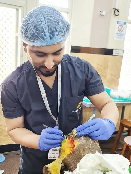 Here I am focused during a hands-on dermatosurgery workshop. My training in surgical dermatology allows me to perform precise procedures for conditions like moles, cysts, and keloids, always prioritizing patient safety and effective results.