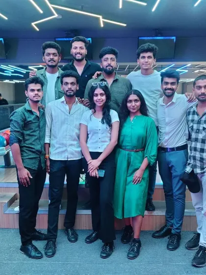 A group of friends posing together at the bowling alley.