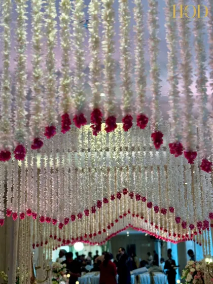 Looking up into the canopy of flowers that formed the entrance tunnel. The layered, scalloped design adds depth and dimension, making the walk-through experience even more magical for guests.