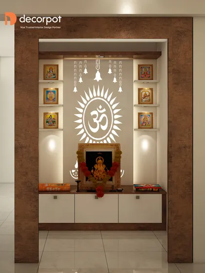 This built-in pooja unit features a dark wood frame and a backlit panel with a sun-like Om design. The white drawers below offer practical storage, keeping the space clutter-free.