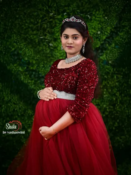 This client looks absolutely regal in our red sequin maternity gown, complete with a tiara for her special photoshoot.