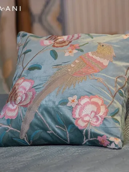 Bring the essence of a tranquil lotus pond into your living space with this teal velvet cushion. The delicate embroidery of a bird among flowers evokes a sense of calm and natural elegance.