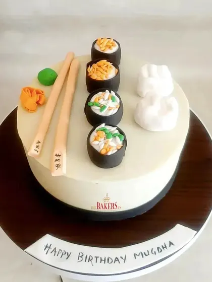 It's Sushi time! A fun and unique cake for a sushi lover's birthday. This cake is topped with handcrafted, edible sushi rolls, wasabi, and chopsticks. The flavor was chocolate and hazelnut.