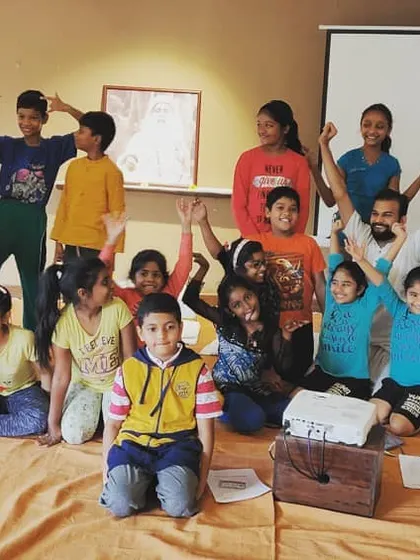 A fun group photo with the kids. The goal is to introduce them to yoga as a joyful process, a tool they can use for the rest of their lives.
