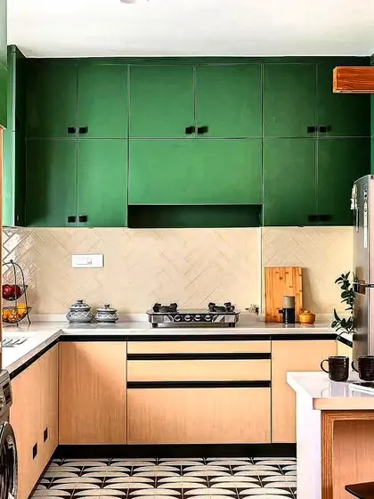A unique kitchen design with forest green upper cabinets, light wood lowers, and a bold patterned floor tile.