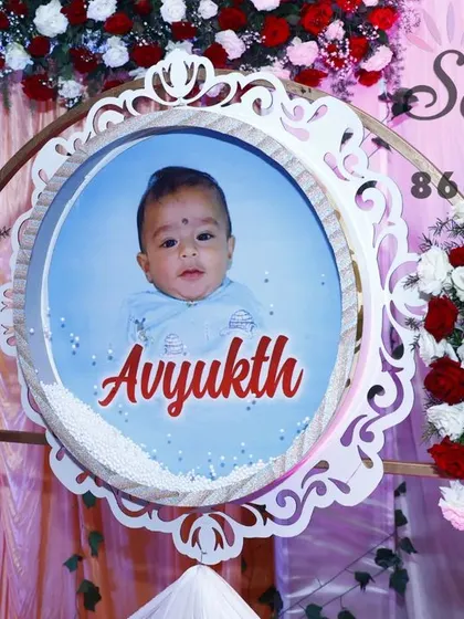A personalized touch for a naming ceremony. We create custom-designed photo frames and signs to celebrate the new baby, surrounded by beautiful floral arrangements.
