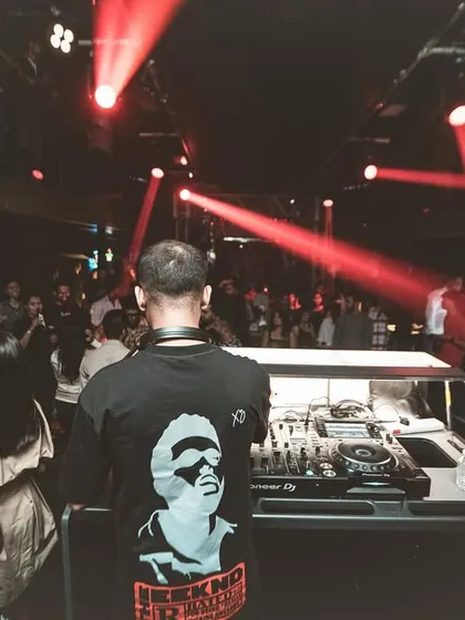 Red lasers slice through the darkness, creating a sharp, energetic visual effect.