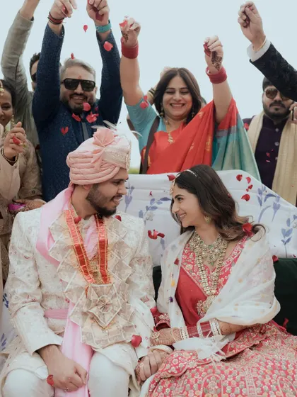 Surrounded by cheering family and friends, the couple shares a look of love and happiness.