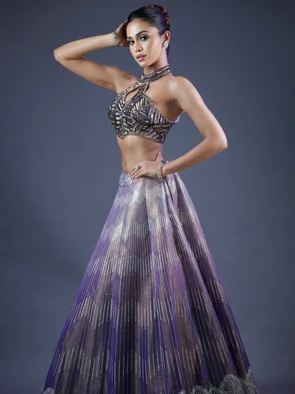 A full-length shot showing the model's powerful pose. The makeup contributes to the overall look of a confident, modern woman.