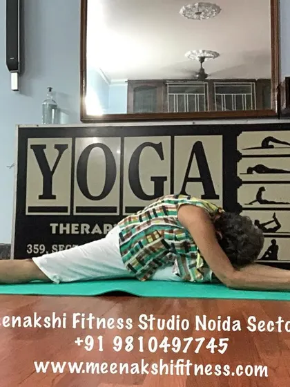 A full forward bend over one leg in a split, a very deep hamstring and hip stretch.