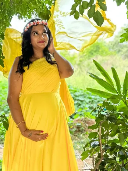 A client looking like a sun-kissed fairy in this bright yellow maternity gown with a flowing trail.