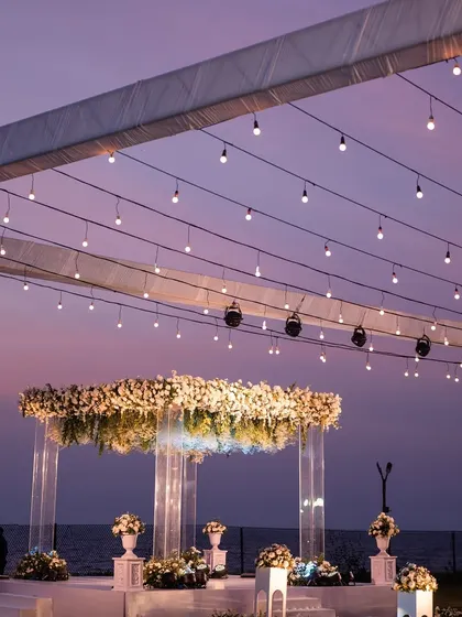 The full view of the sundowner setup in Goa, with the purple sky creating a stunning contrast with the warm fairy lights.