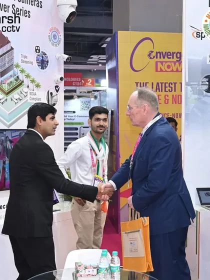 A handshake symbolizing a new partnership at IndiaSoft & Convergence 2025. Every connection is a step towards a more secure world.
