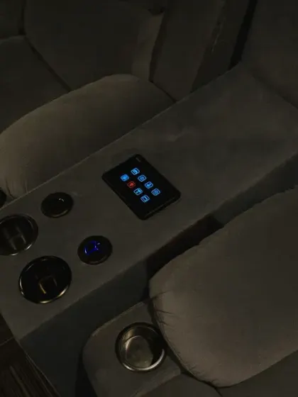 Here is another angle of the recliner with the integrated touch panel. The subtle blue backlighting of the panel is designed to be visible in a dark theater without being distracting.