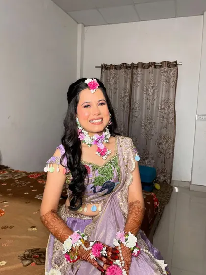 A full-length shot of the Haldi bride. Her lavender lehenga with peacock embroidery is unique and beautiful.