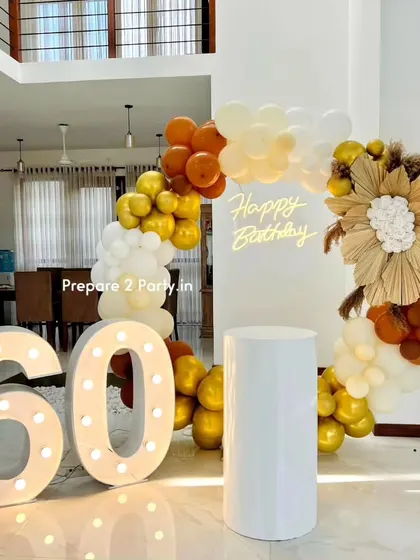 These close-ups of the 60th birthday decor highlight the detailed floral work made of dried palms and artificial roses, and the warm glow of the neon and marquee lights.