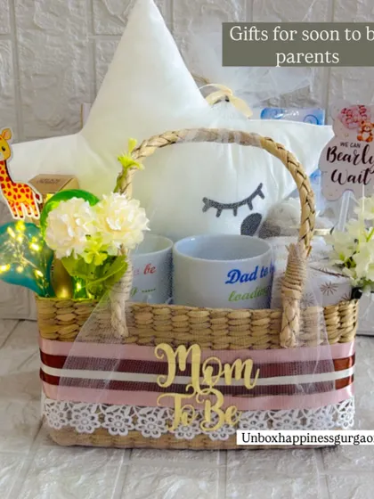 This hamper for soon-to-be parents includes a "Mom To Be" basket sash, "Dad to be loading" mug, and a cute giraffe accent.