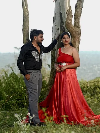 A quiet, intimate moment in the woods. The red of her gown is a beautiful pop of color against the green foliage.
