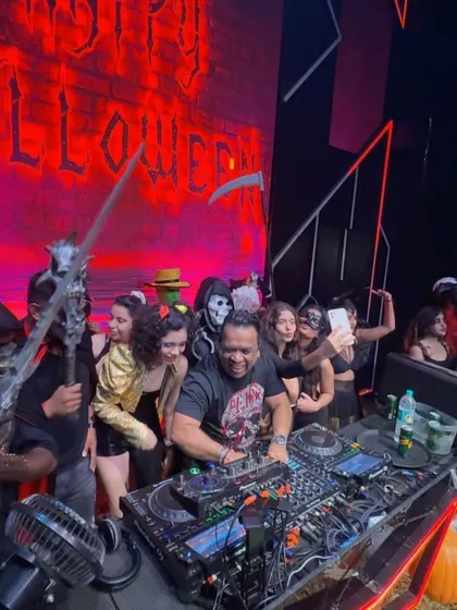 Surrounded by ghouls and ghosts behind the decks. I love when the crowd gets creative for themed parties like this Halloween bash.