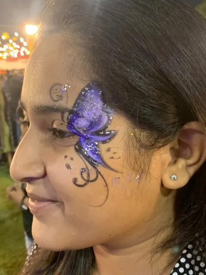 A purple butterfly with intricate black details and a dusting of glitter.