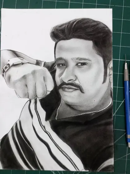 The finished portrait for a client from Karnataka, shown on my work mat next to the pencils I used to create it.