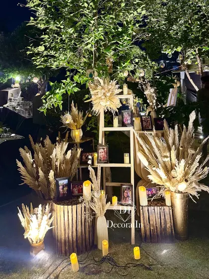 The memory ladder glowing at night, with spotlights and candles creating a warm and sentimental corner for guests to enjoy.