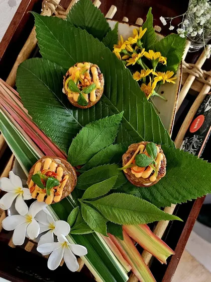 Our Thai-Haitian chicken sliders, artfully arranged with tropical flowers and leaves.