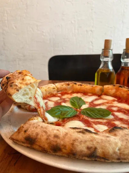 A perfect slice of Margherita, showing off the simple, beautiful ingredients.