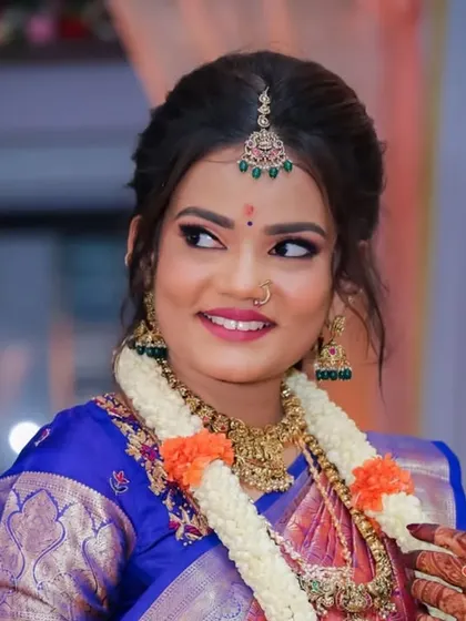 A candid portrait of the bride looking away with a happy smile. These unposed shots capture a natural elegance and grace.