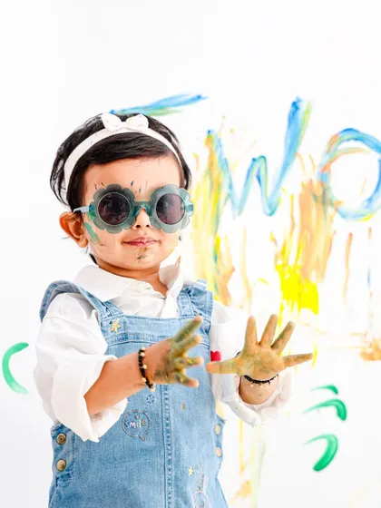 It's all about the fun details. A close-up shot of paint-covered hands and cool sunglasses shows off the playful spirit of our paint and play photoshoots.