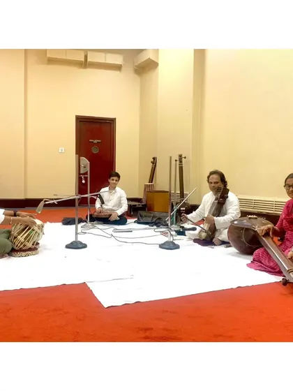A recording in progress for the National Programme of Akashvani, All India Radio. This setup shows a traditional quartet with sarengi, tanpura, and tabla, captured for a national broadcast.
