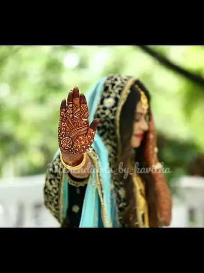 Another shot from a bridal photoshoot, highlighting the deep color of the henna stain. The detailed patterns on the hand and arm look even more beautiful once the color has fully developed.