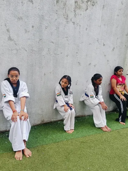 Students hold their wall sits with determination. This is where character is built, long before they ever step into a competition ring.