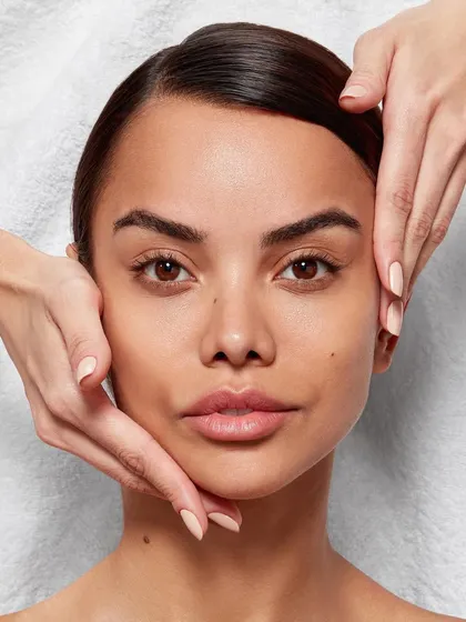 A serene beauty shot emphasizing a gentle facial massage. This image conveys a sense of professional care and self-care, perfect for spa-grade skincare or facial service advertising.