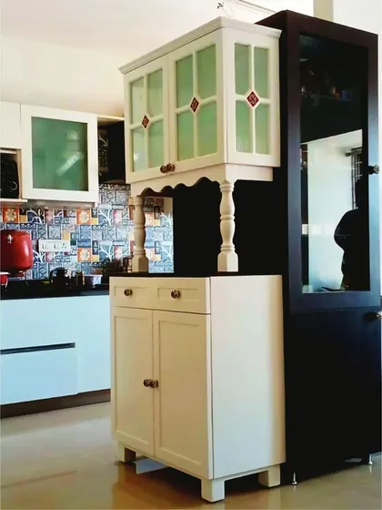 A unique, compact crockery unit with stained glass details, designed to fit into a smaller space while still providing stylish storage.