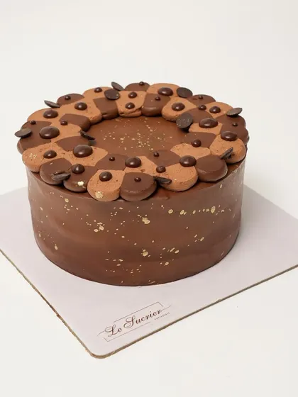 My bestselling Belgian Chocolate Mousse Cake, ready for a celebration. It's made with layers of moist chocolate sponge, chocolate chips, and a melt-in-your-mouth mousse.