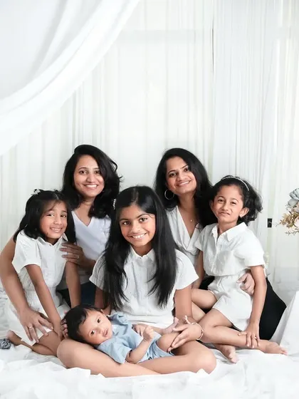 A beautiful gathering of cousins and aunts, all dressed in white. This photo is a timeless keepsake of the women in the family.